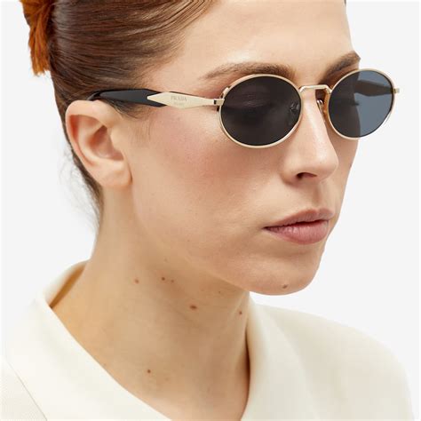 prada new round sunglasses gold|cost of prada sunglasses.